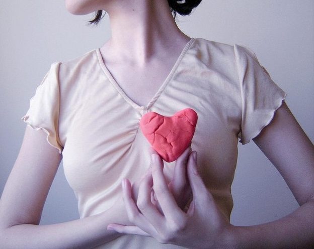 Woman Holding Heart. Photo by Gabriela Camerotti
