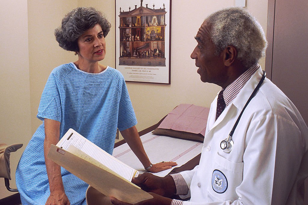 Doctor Consults with Patient.  Courtesy of NIH
