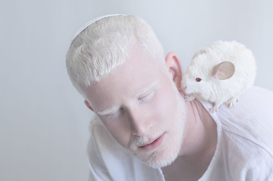 Albino with mouse. Photo by  Yulia Taits