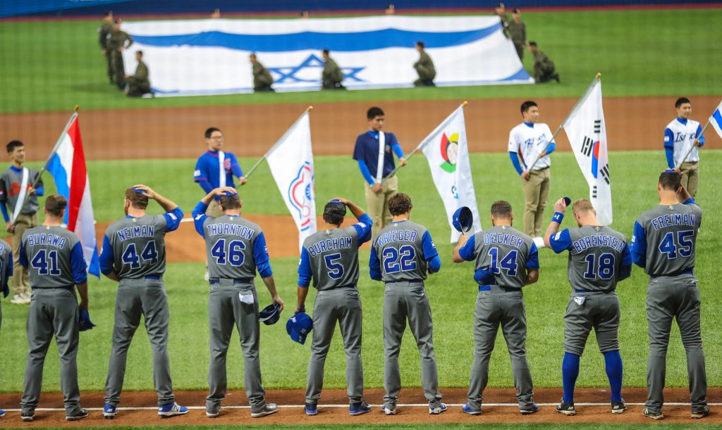 Members of Team Israel remove their caps and put on their yarmulkes for the Israeli national anthem. Courtesy