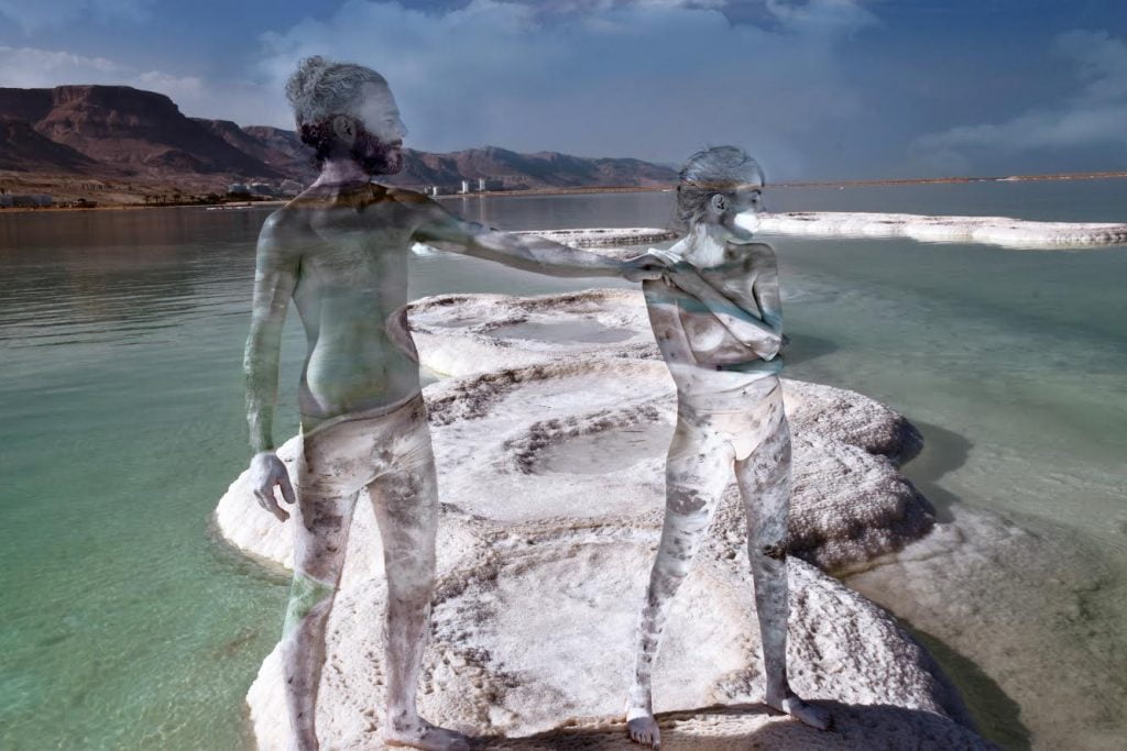Two of Avi Ram's models in camouflage body paint at the Dead Sea. Courtesy of Avi Ram
