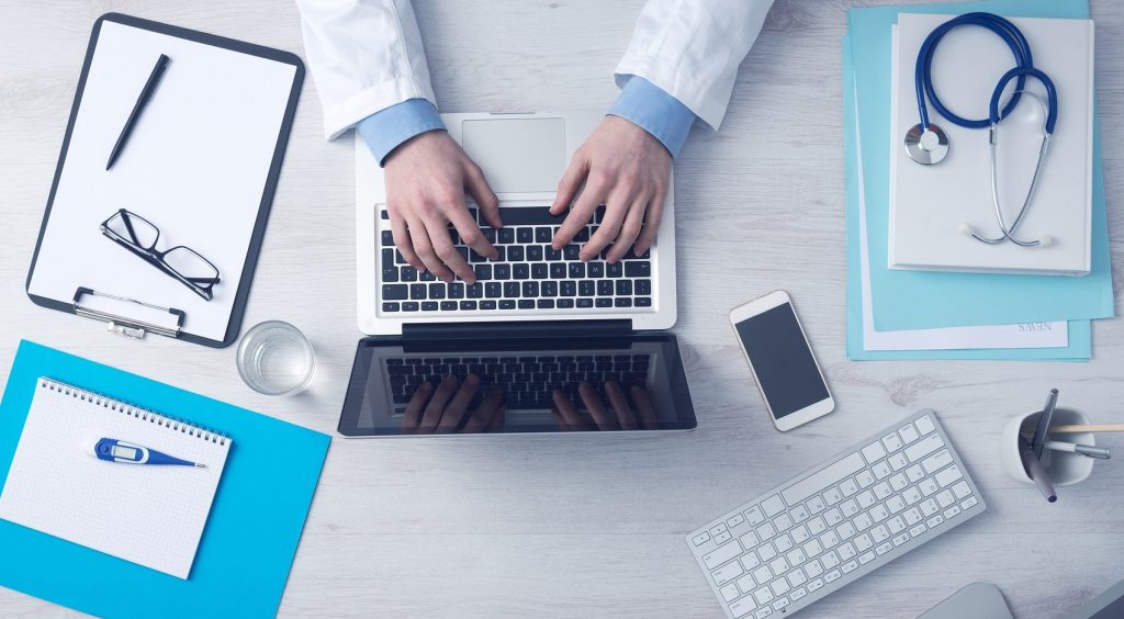 An illustrative photo of a doctor on a computer. Photo by Pixabay