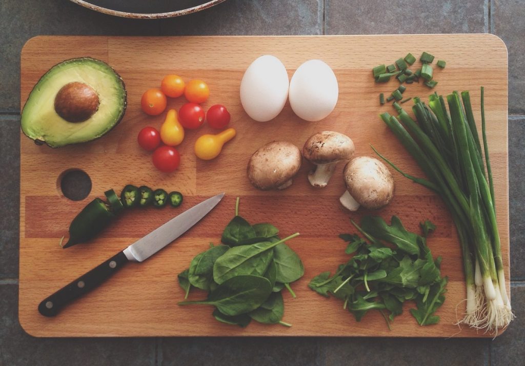 An illustrative photo of vegetables on a chopping board. Unsplash