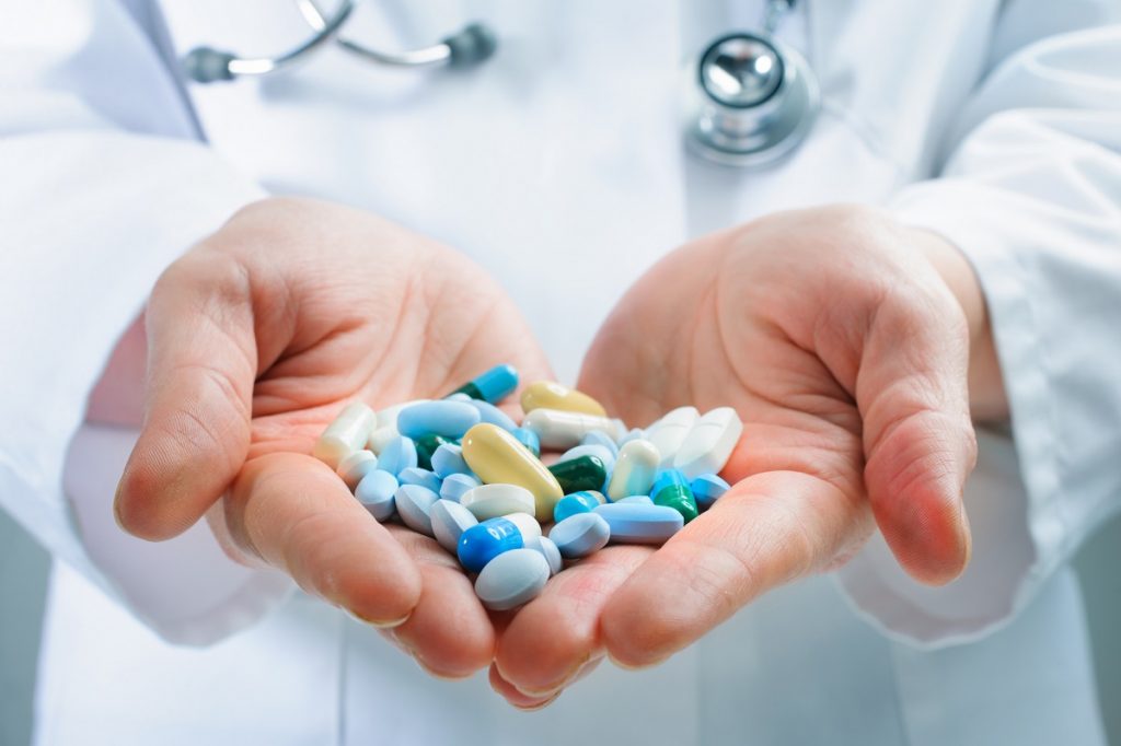 An illustrative photo of a doctor holding different types of pills. <a href="http://dep.ph/v/3jenyy-bsat0" target="_blank">Photo via Deposit Photos</a>