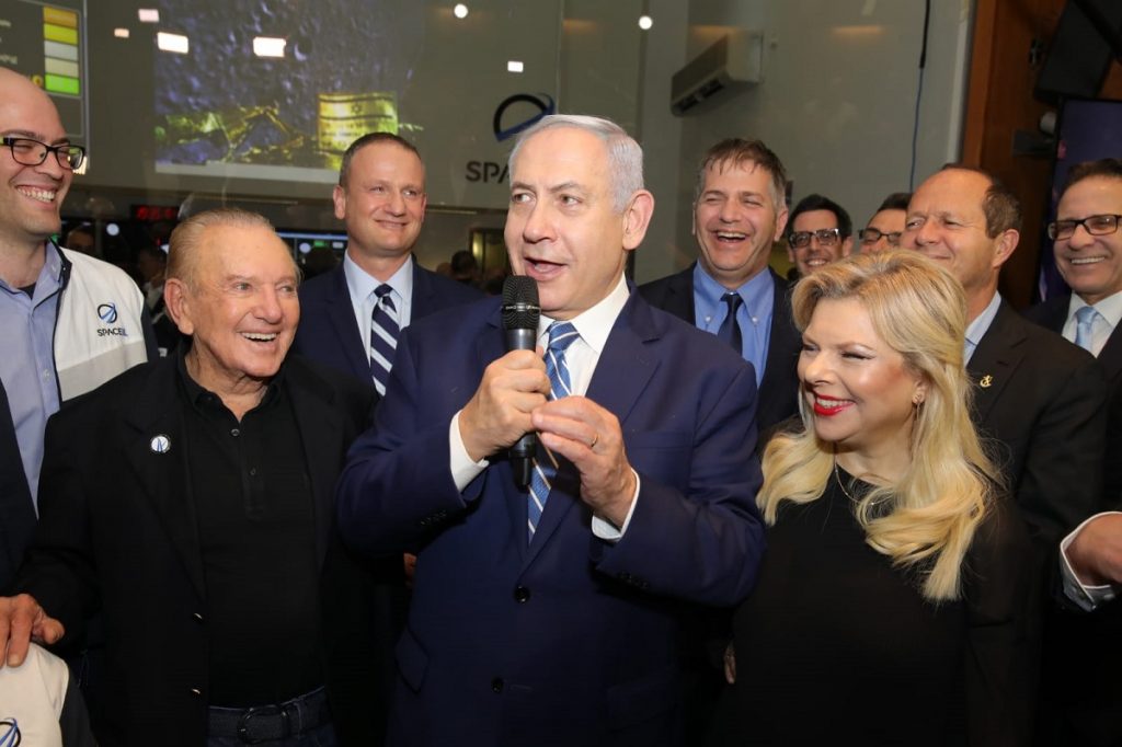 Prime Minister Benjamin Netanyahu with his wife Sara, and SpaceIL President Morris Kahn, left, at the Beresheet control room in Yehud, April 11, 2019