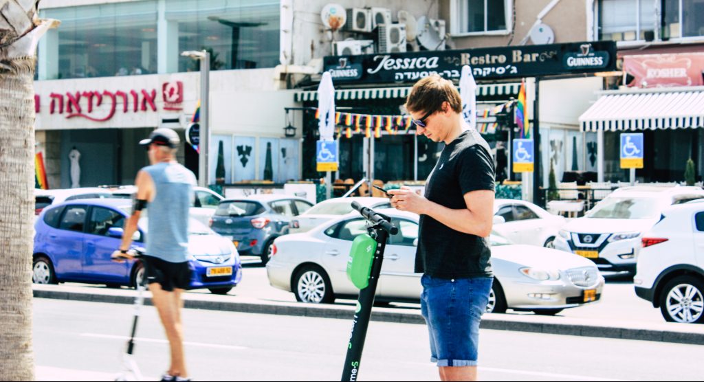 People riding electric scooters in Tel Aviv. Deposit Photos