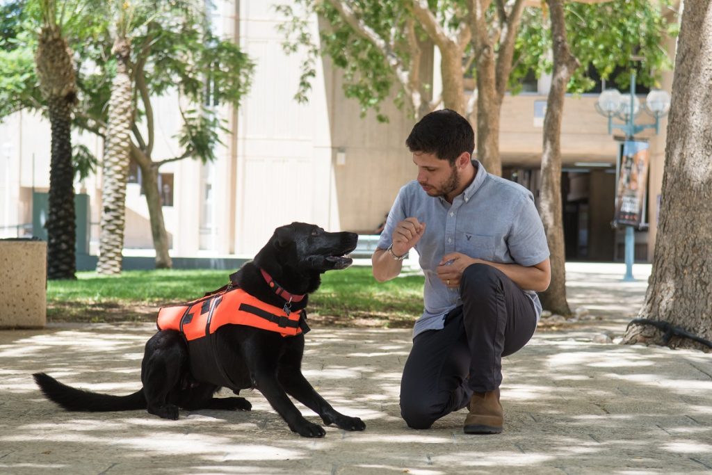 BGU PhD student Yoav Golan, with his dog Tai, test haptic tech for dog training. Courtesy