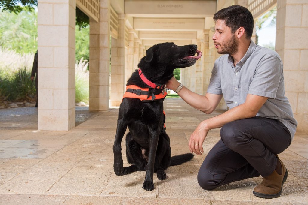 BGU PhD student Yoav Golan, with his dog Tai, test haptic tech for dog training. Courtesy
