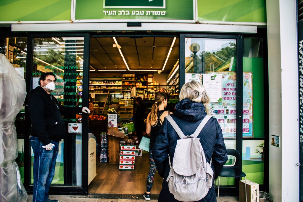 People in Tel Aviv wait in line at a grocery store. April 2020. Deposit Photos