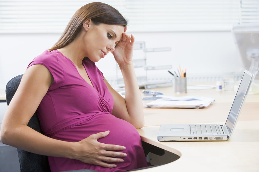 Pregnant Woman at Desk via BigStock
