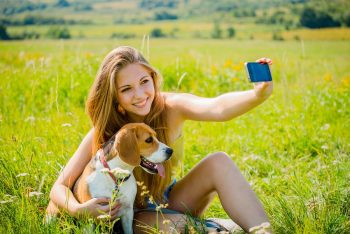 Dog and woman taking picture