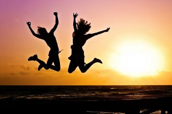 happy young people jump beach via Pixabay