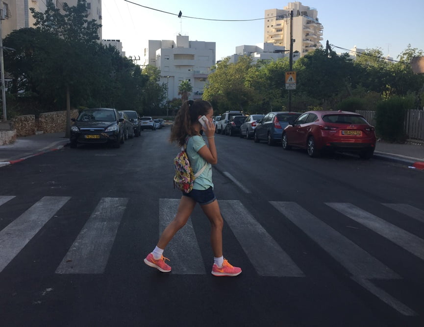 Girl Crossing the Street While Talking on her Smartphone. Photo by Einat Paz-Frankel