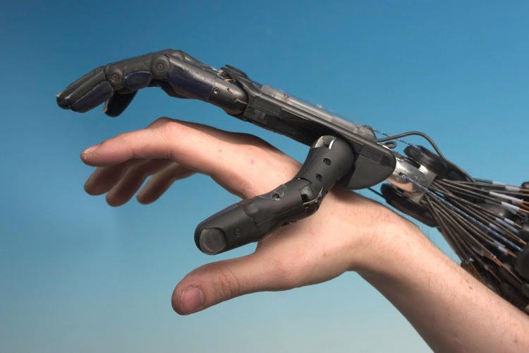robot hand with human hand via Wikimedia