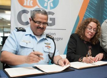 Israel Police Commissioner Roni Alsheikh and BGU President Prof. Rivka Carmi sign the agreement to create the Center for Computational Criminology during a ceremony at BGU's Advanced Technologies Park in Beesheba on February 28, 2018. Courtesy