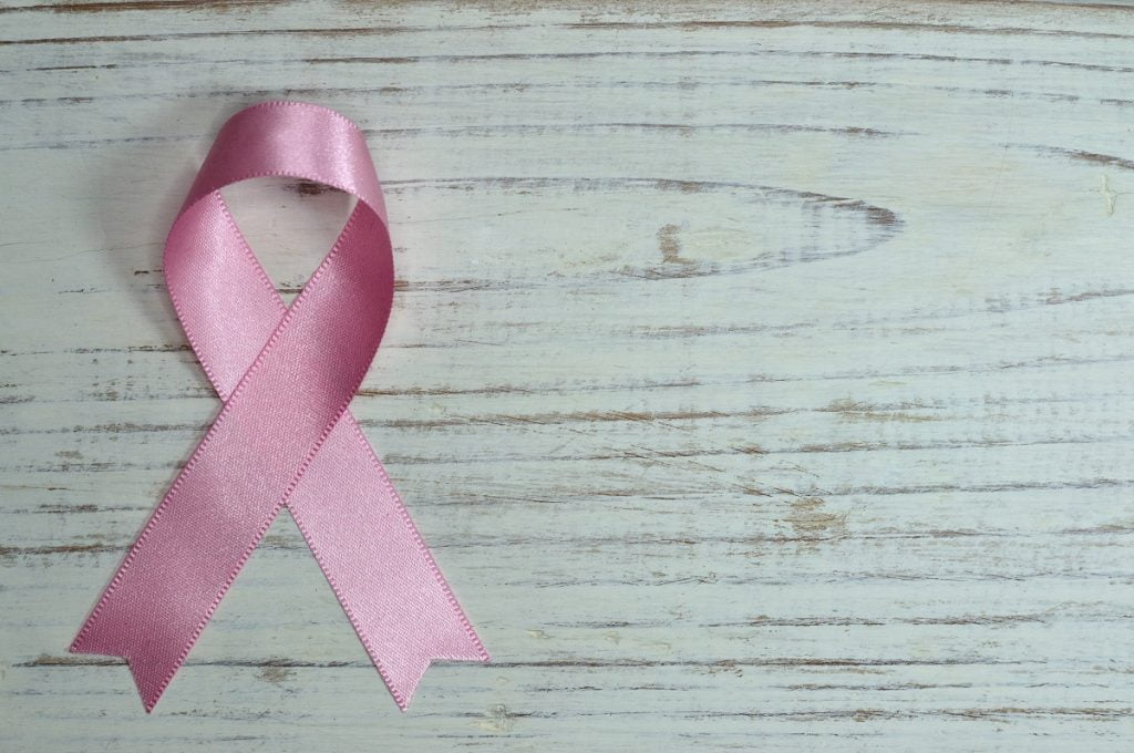 A pink ribbon that signifies breast cancer awareness. Photo by Miguel Á. Padriñán from Pexels