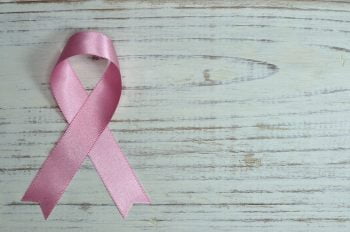 A pink ribbon that signifies breast cancer awareness. Photo by Miguel Á. Padriñán from Pexels