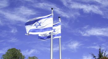 Israeli flags flying. Photo via zeevveez on Flickr, CC BY 2.0