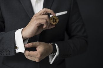 A person holding a Bitcoin. Pixabay