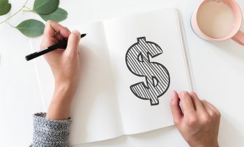 A drawn dollar sign in a notebook. Pexels
