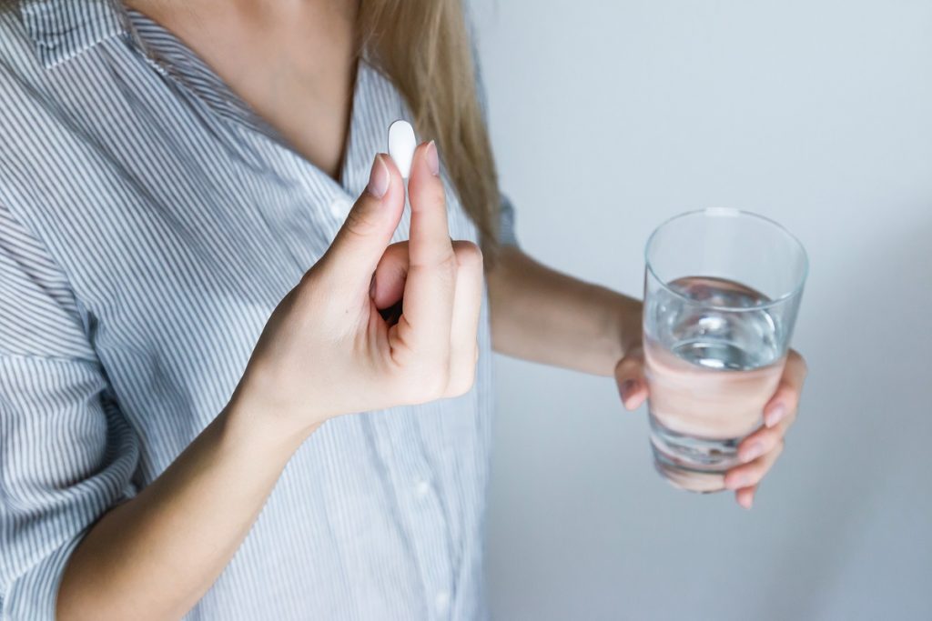 An illustrative photo of a person holding a pill. Photo via Pexels