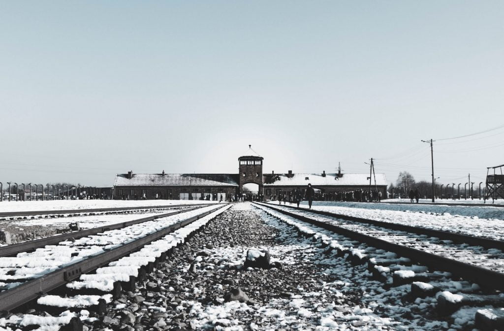 The tracks leading to the Auschwitz concentration camp operated by the Nazis in Poland. Photo via Unsplash