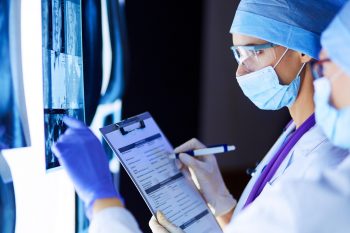 Illustrative: Doctors looking at a medical image. Photo via Deposit Photos