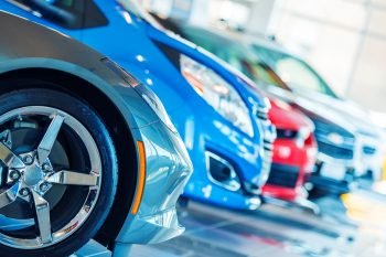 Cars in a showroom. Photo via Deposit Photos