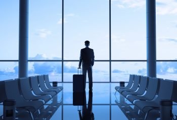 A businessperson in an airport. Photo via Deposit Photos