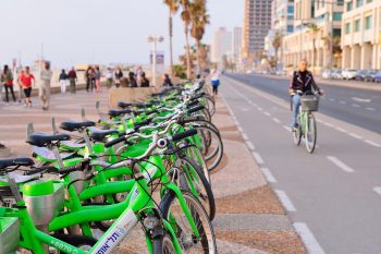 Parked bicycles in the center of Tel Aviv along a seaside bike path.