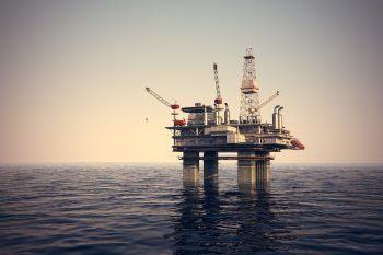 An illustrative photo of an oil platform at sea. Deposit Photos