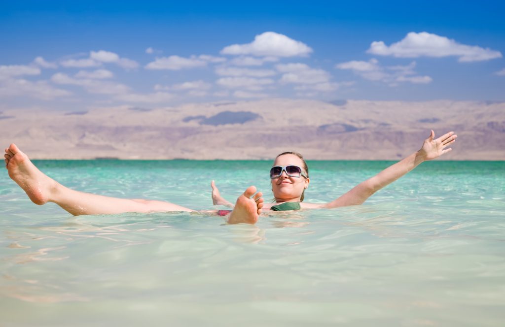 A woman floating in the Dead Sea. Illustrative. Deposit Photos