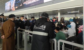 Passengers wearing masks going through an extra body temperature check as part of airport security in northeast China's Changchun Longjia Airport, January 26, 2020. Wikimedia