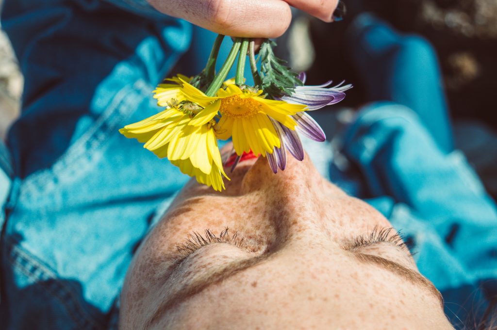 person smelling flowers