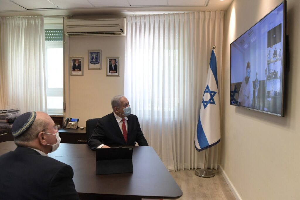 PM Benjamin Netanyahu speaks with IIBR Director General Prof. Shmuel Shapira via viodeconference. Photo: Kobi Gideon