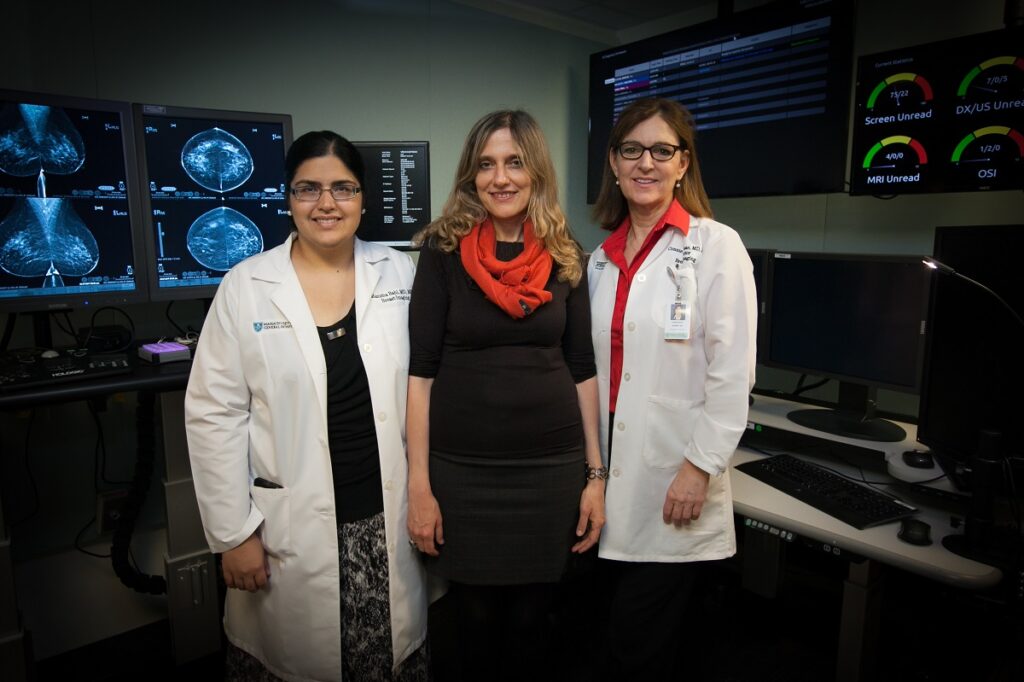 MIT professor Regina Barzilay (center) with MGH collaborators Manisha Bahl and Constance Lehman in front of mammogram images. Photo: Jason Dorfman, MIT CSAIL