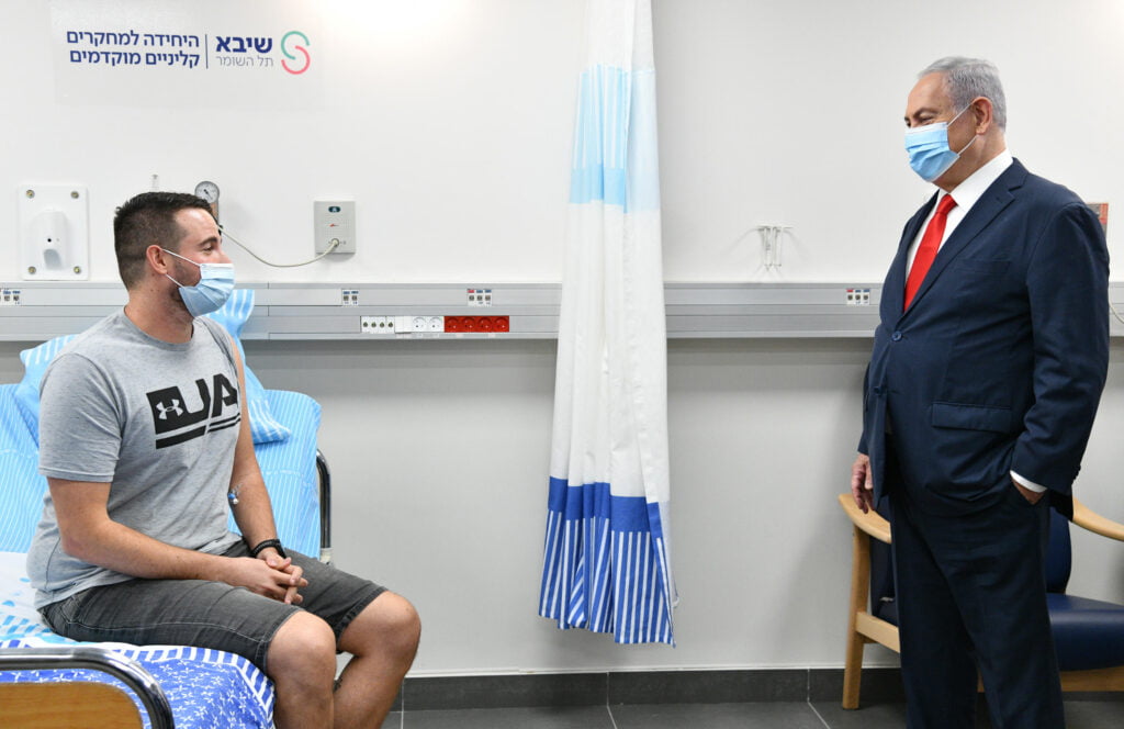 Prime Minister Benjamin Netanyahu meets with Segev Harel, 26, Israel's first volunteer to receive the locally-developed COVID-19 vaccine. Photo: Haim Zach / GPO