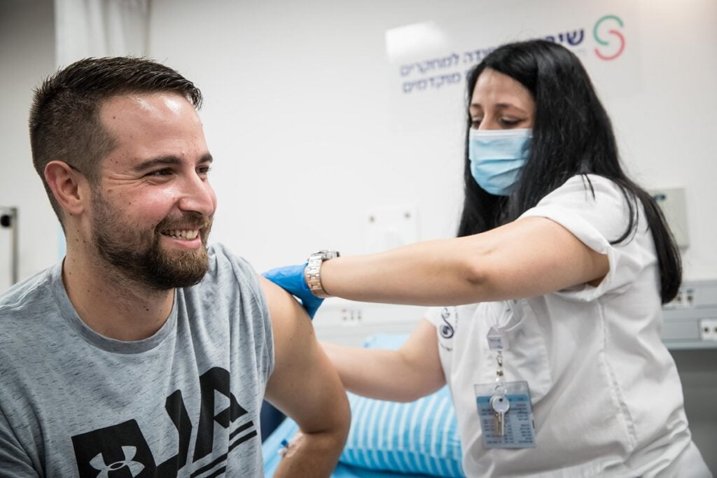 The first COVID-19 vaccine developed by the Israel Institute of Biological Research is administered by nurse Hela Litwin to volunteer Segev Harel, 26, at the Sheba Medical Center, November 1, 2020. Photo: Ministry of Defense Spokesperson’s Office