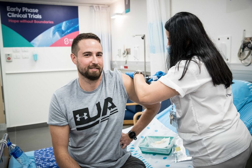 The first COVID-19 vaccine developed by the Israel Institute of Biological Research is administered by nurse Hela Litwin to volunteer Segev Harel, 26, at the Sheba Medical Center, November 1, 2020. Photo: Ministry of Defense Spokesperson’s Office