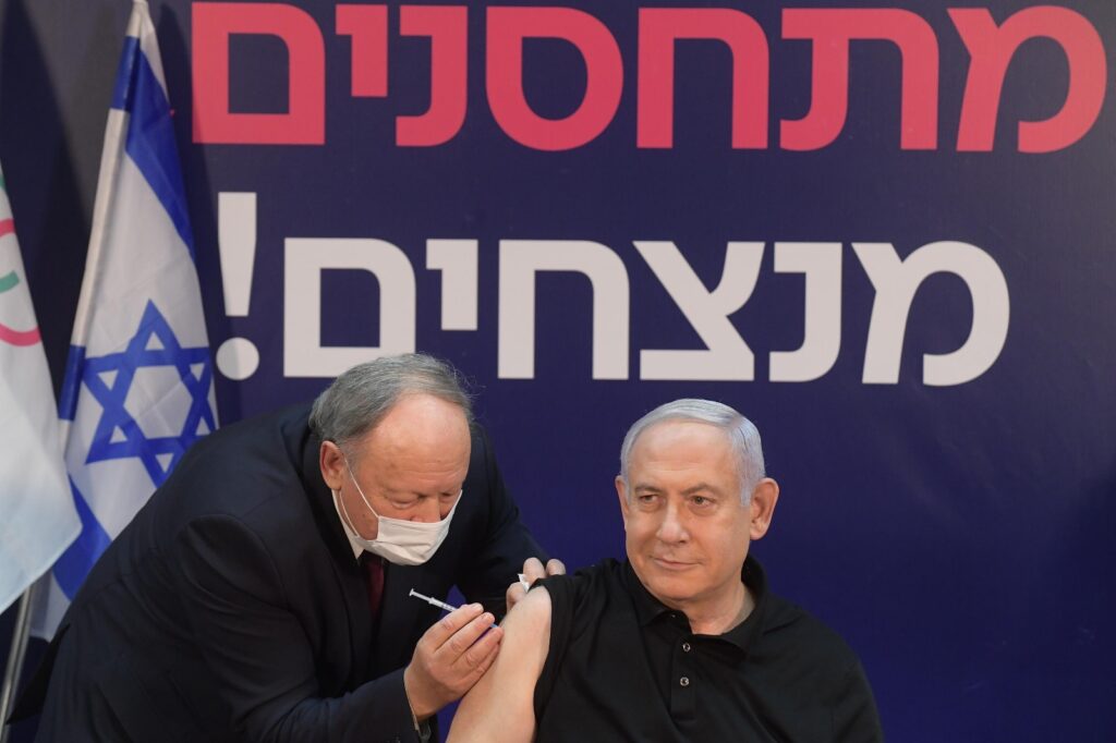Prime Minister Benjamin Netanyahu receives a vaccine for COVID-19, December 19, 2020. Photo: Amos Ben-Gershom/GPO