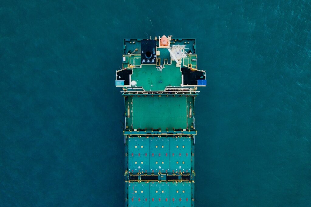 A cargo ship at sea. Photo by CHUTTERSNAP on Unsplash