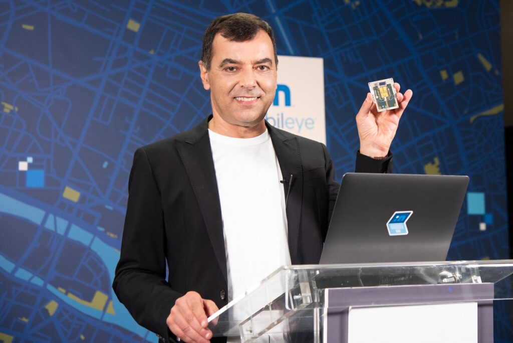 During his annual 'Under the Hood' address at the all-virtual CES 2021, Prof. Amnon Shashua, president and CEO of Mobileye, shows off a new silicon photonics lidar SoC that will deliver frequency-modulated continuous wave (FMCW) lidar on a chip for autonomous vehicles beginning in 2025. Photo: Intel Corporation