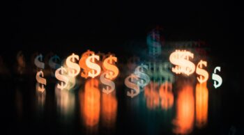 An illustrative photo of dollar signs. Photo by Chronis Yan on Unsplash