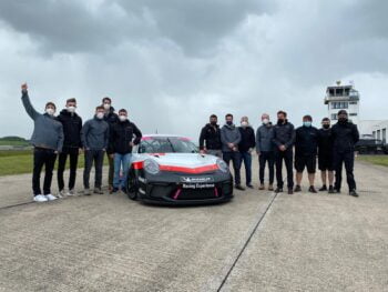 The Griiip team with members of Porsche Ventures gather at a race car track in Germany. Photo: Griiip