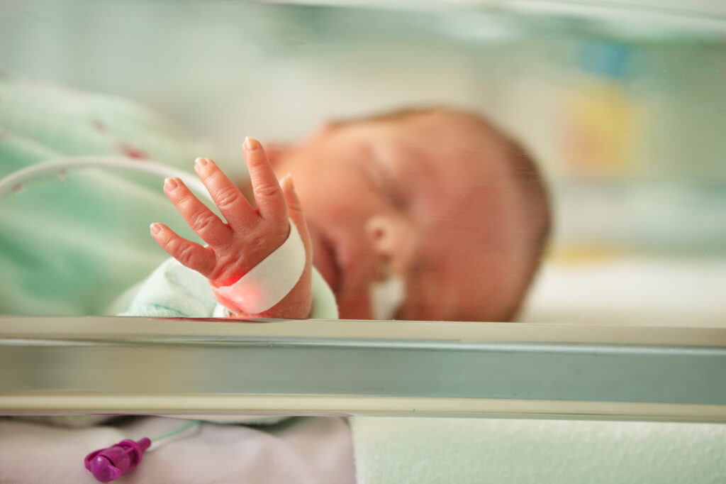 Heart rate monitor and hand of a baby infant in ICU